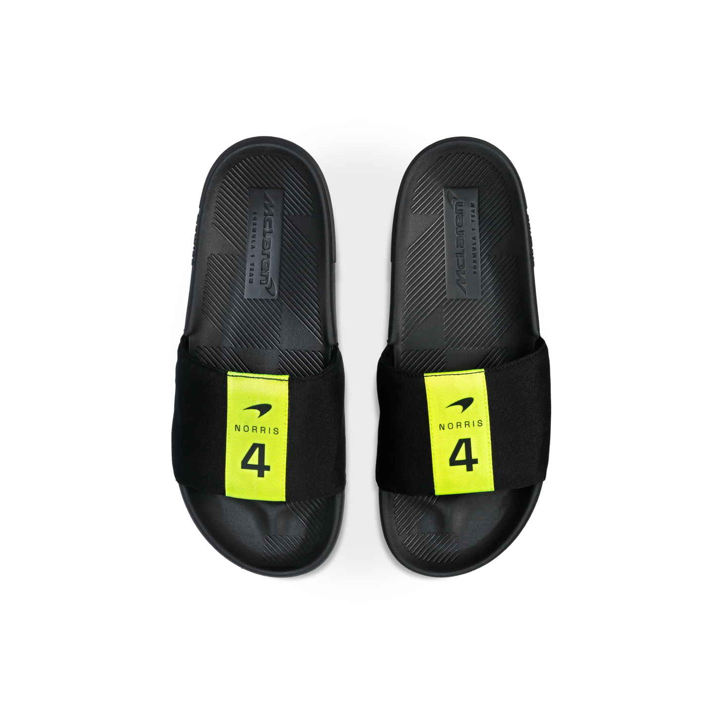 McLaren x K-Swiss black slide sandals with yellow Norris 4 footbed branding – top view of pair
