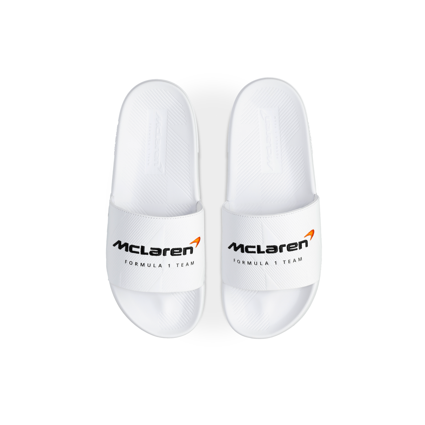 McLaren x K-Swiss white slide sandals with McLaren Formula 1 Team logo straps – top view of pair