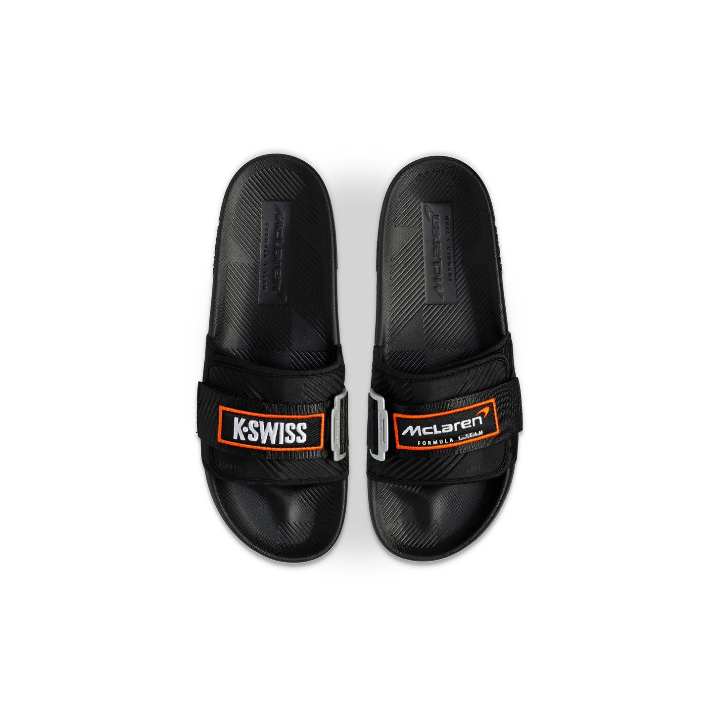 McLaren x K-Swiss black strap sandals with McLaren Formula 1 footbed branding – top view of pair