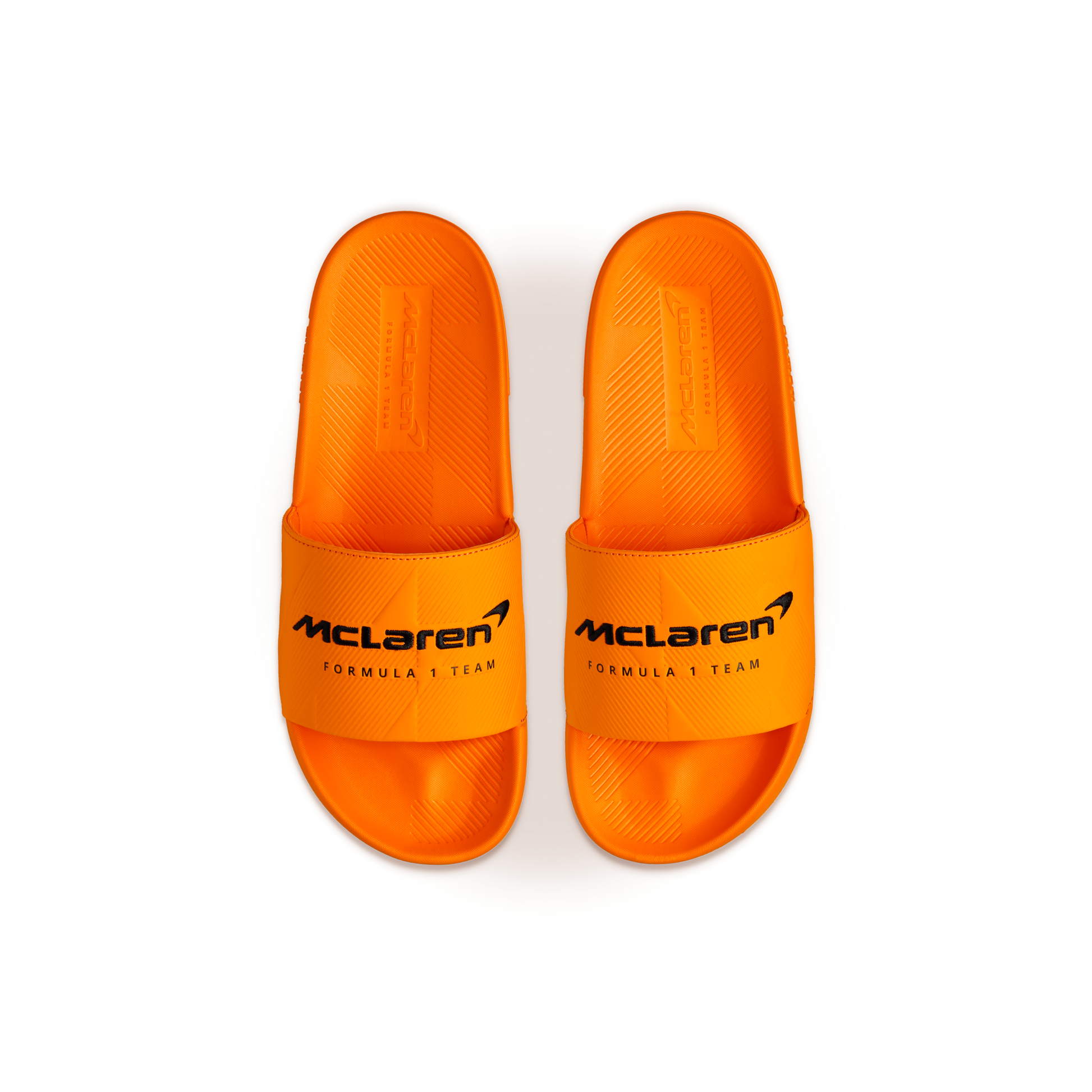 McLaren x K-Swiss papaya orange slide sandals with McLaren Formula 1 Team logo straps – top view of pair