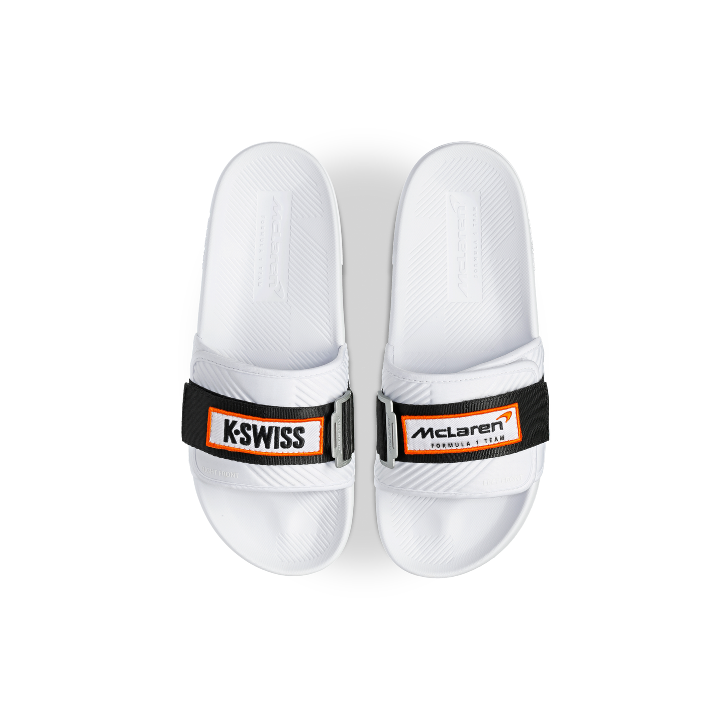 McLaren x K-Swiss white strap sandals with McLaren Formula 1 footbed branding – top view of pair