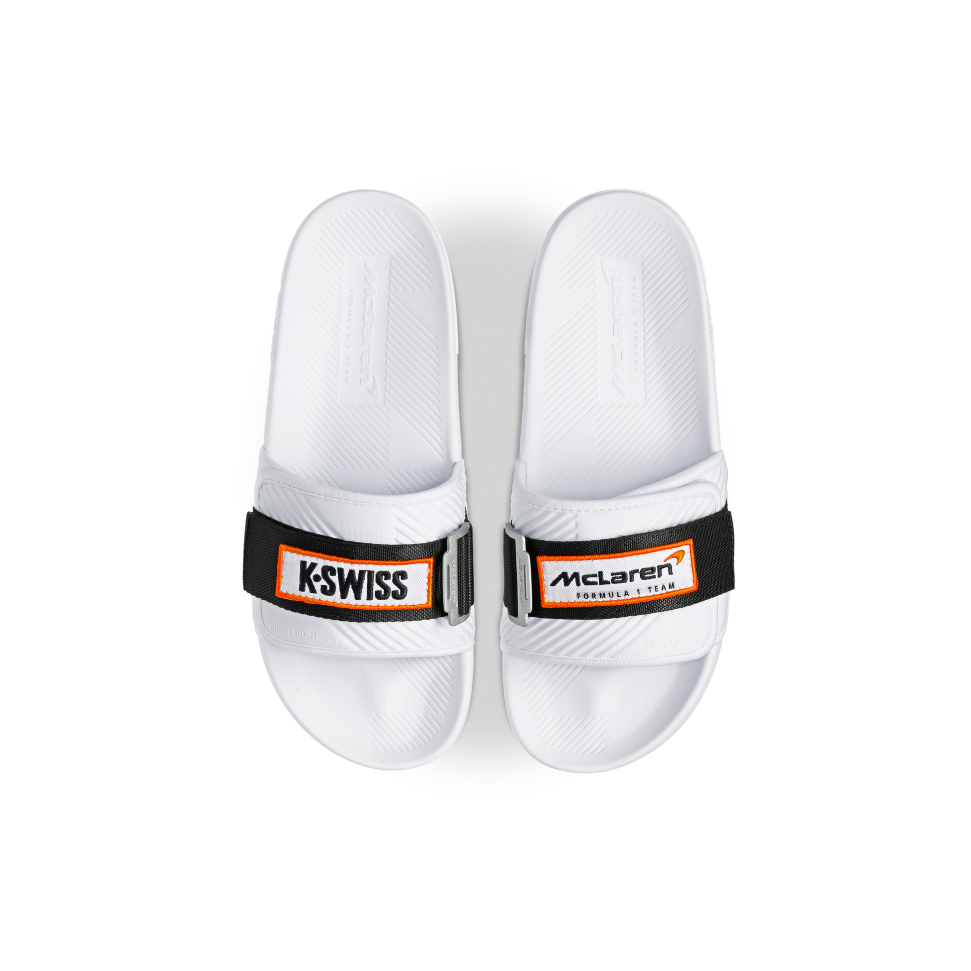 McLaren x K-Swiss white strap sandals with McLaren Formula 1 footbed branding – top view of pair